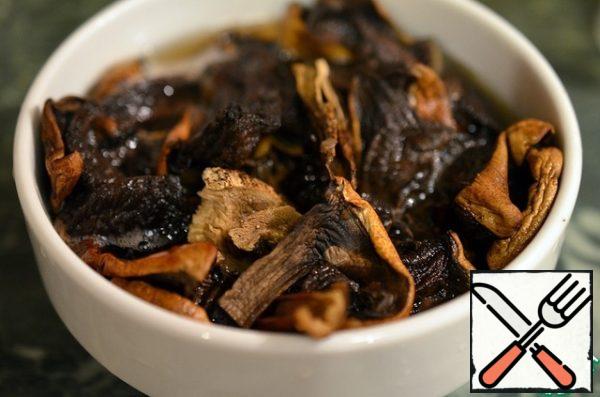 Wash the mushrooms and soak them in hot water for an hour.