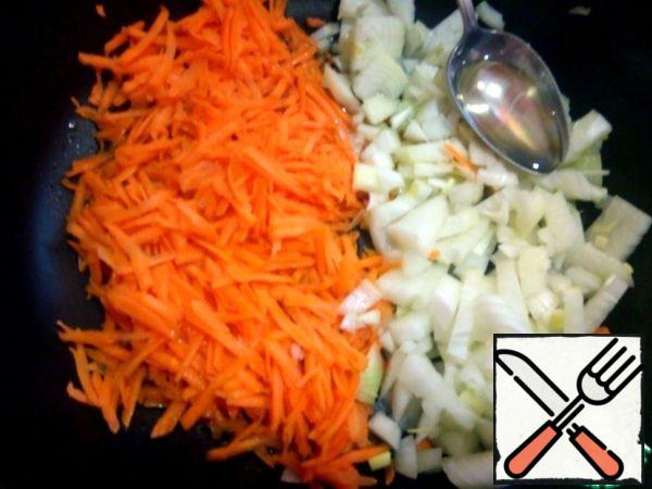 While the cabbage is cooking, put a soup pot with 1.5 liters of water on the stove. Put the pan on the fire to fry the vegetables.
Peel the carrots, onions. Grate the carrots on a coarse grater, cut the onion into small cubes. send the vegetables to the pan with the addition of 3 tablespoons of oil, simmer the vegetables over low heat.