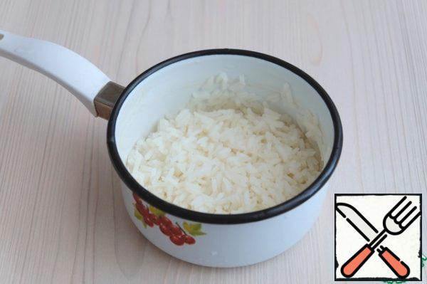 Boil rice in salted water until cooked.
Then rinse with warm boiled water.