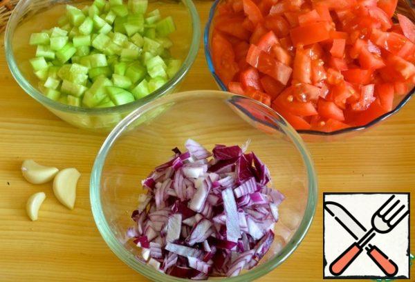 Tomatoes, cucumber and onion cut into cubes,
garlic to clear and chop.