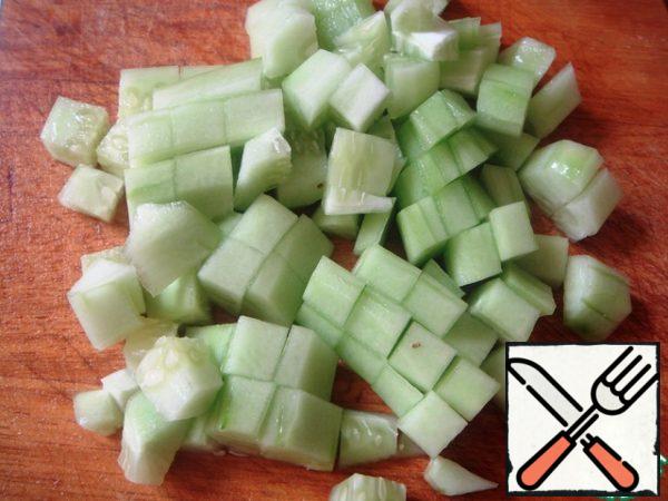 Wash all vegetables, peel cucumbers (and remove large seeds, if any), cut into cubes.
