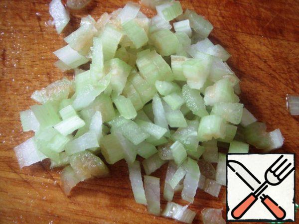 Finely chop celery, add to the tomatoes with the cucumber.