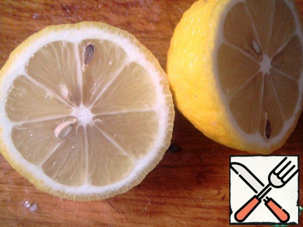 Squeeze the juice of half a lemon into a saucepan.
