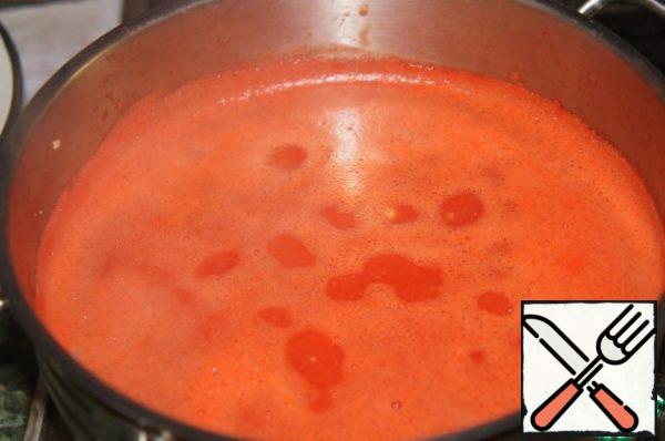 The tomato mixture is poured into boiling fish broth.
