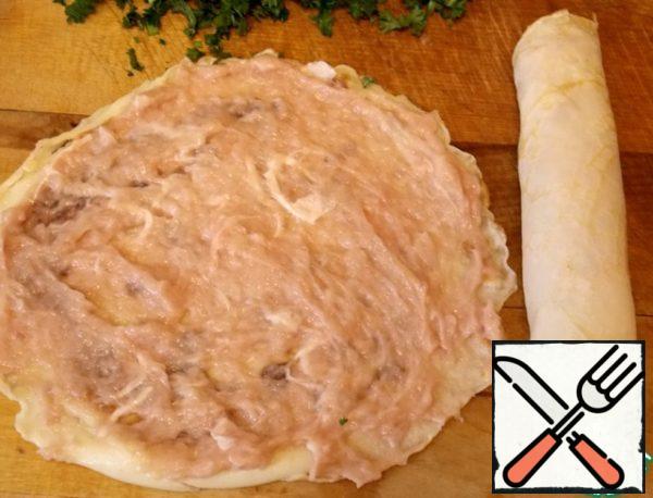 While the broth is being prepared, we are preparing pancakes. To do this, mix milk, eggs, salt, flour. Mix well. Grease a frying pan with oil and bake thin pancakes. Let it cool down. Mix the minced meat with cream. Grease each pancake with chicken mousse rolled into a roll.