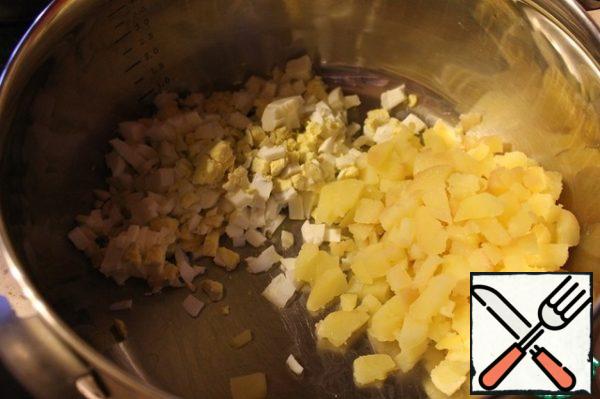 Boil potatoes and eggs, cool them and cut them into small cubes.