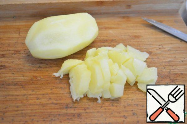 Boil potatoes, cool them completely and cut them into cubes.