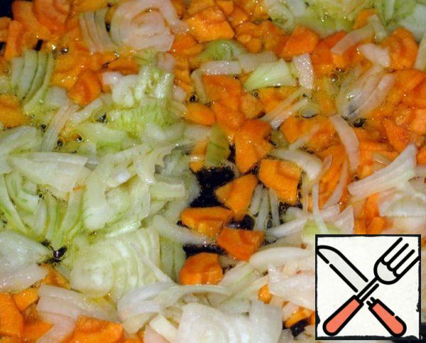 Cut and fry onions and carrots in vegetable oil.
