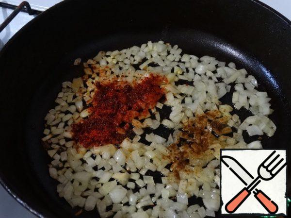 Fry onion until transparent in the remaining olive oil, add paprika and red pepper.