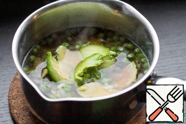 Avocado cut in half and with a spoon to get the pulp, add it to the soup. Boil the soup for 10 minutes on low heat.