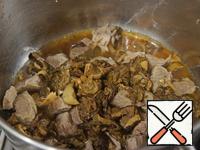 Cut the meat into pieces. In a saucepan with a thick bottom heat the oil and brown the meat, add the soaked, chopped mushrooms. Fill with water, bring to a boil and cook over low heat for 30 minutes.