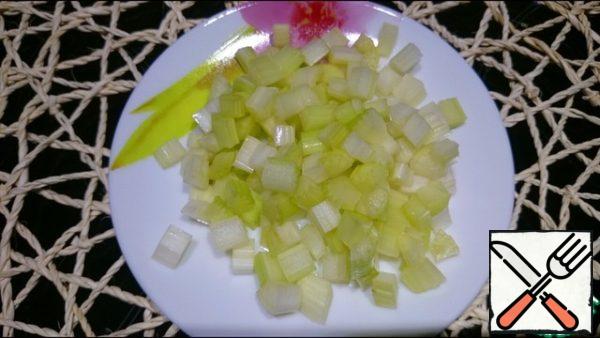 Celery is cut into small cubes and added to the broth.
