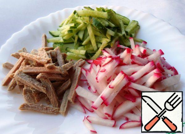 Cucumbers, radishes and boiled beef cut into strips.
