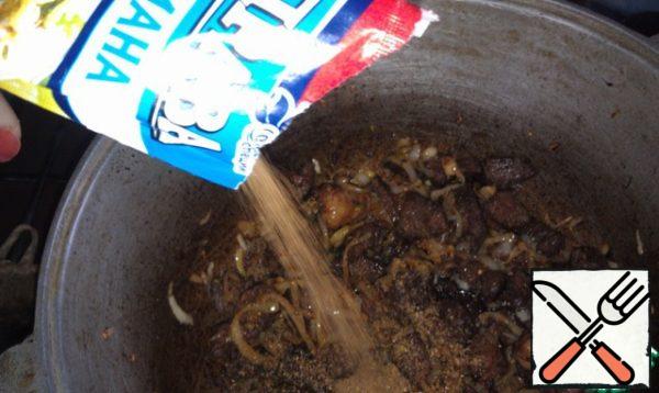Add the onions, stir, fry until Golden state. Lower the fire. Add the spices for lagman. Stir.