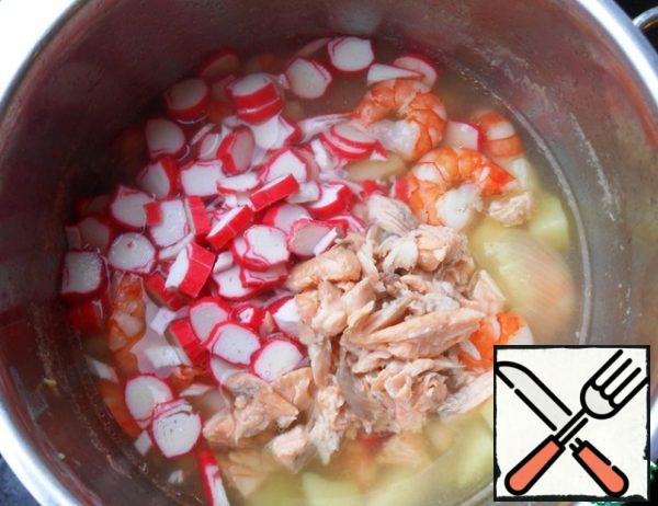 Add crab sticks and fish, bring to a boil and remove from heat.