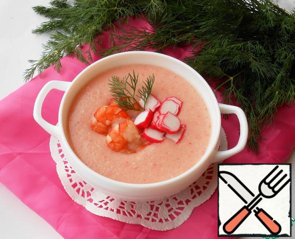 Pour soup on plates, decorate with delayed shrimps and crab sticks, a sprig of dill.