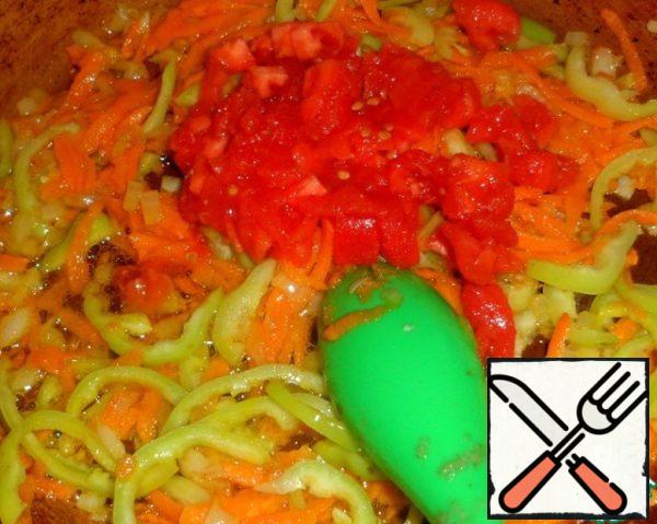 Add sliced tomatoes without skin to the vegetables. Simmer, stirring, for a couple of minutes.
