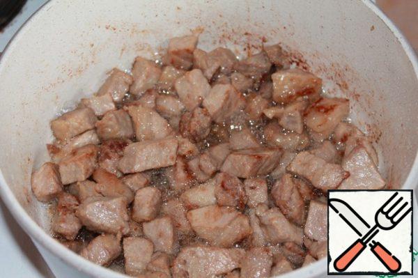 Fry the meat in a saucepan or in a cauldron with a thick bottom in vegetable oil until golden brown.
