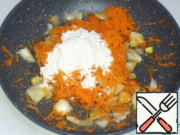 In a pan, poured oil, put chopped onion, grated carrot, added the flour. 