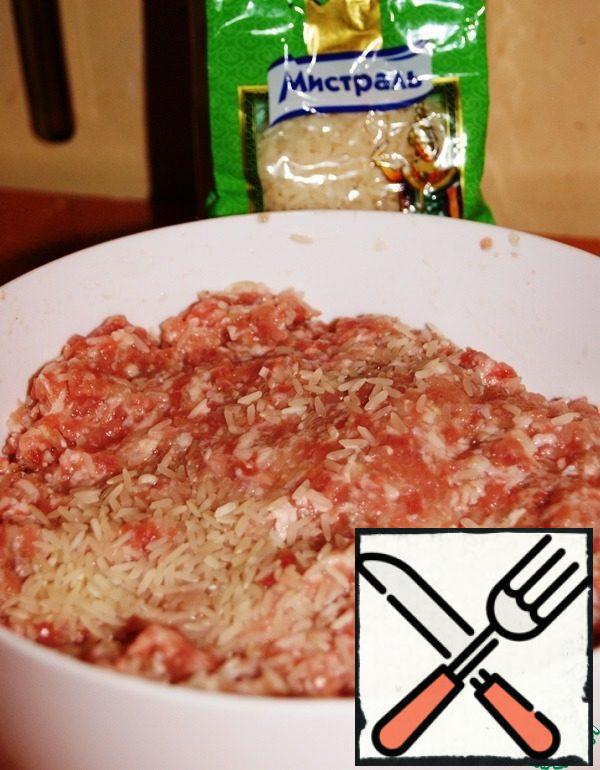 Add 1 onion grated on a grater to the minced meat, passed through the press garlic, rice, water, salt and pepper and mix well. Leave at room temperature for 1 hour.