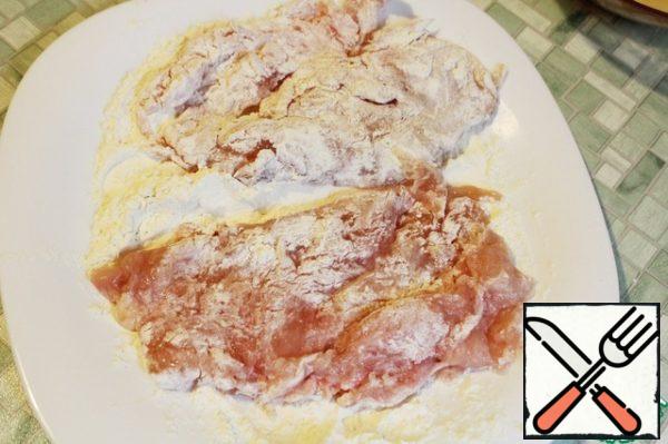 Roll the chicken in flour on all sides.