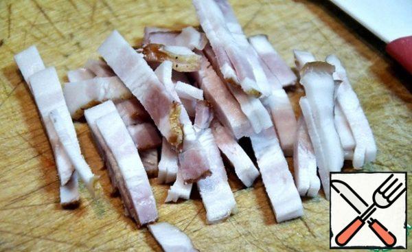 Cut bacon into strips.
