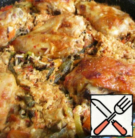 Put in a preheated 200 degree oven, after 10 minutes, reduce the heat to 160, cover with foil or lid and cook until the rice is soft and liquid is absorbed. If the rice is still raw, and the liquid is gone, pour a little boiling water. Remove the foil and brown the top of the chicken.