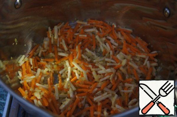 Add the carrots and celery and fry them until soft for 3 minutes.