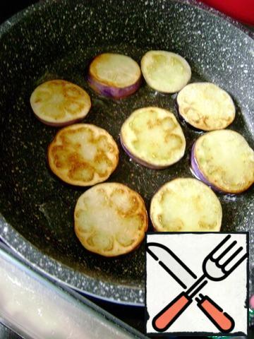 Cut eggplant into not to thin slices and fry until light blush. 