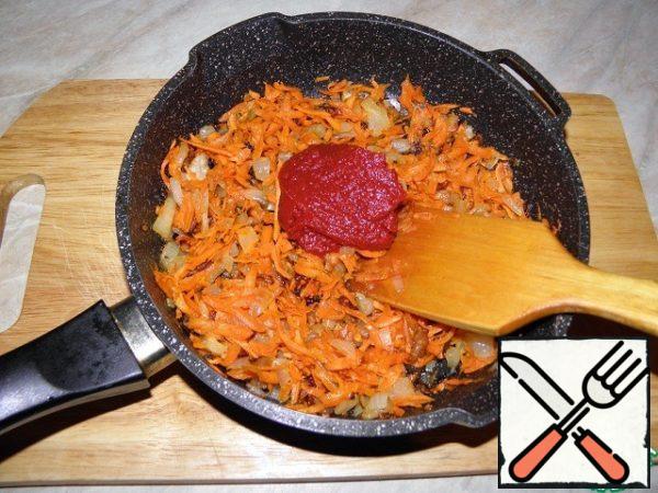 Then add tomato paste (or tomatoes) to the onions and carrots.
