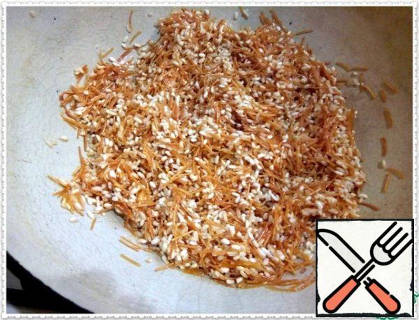 Rice should turn white, and noodles to purchase caramel color. Once that happens, turn down the fire.