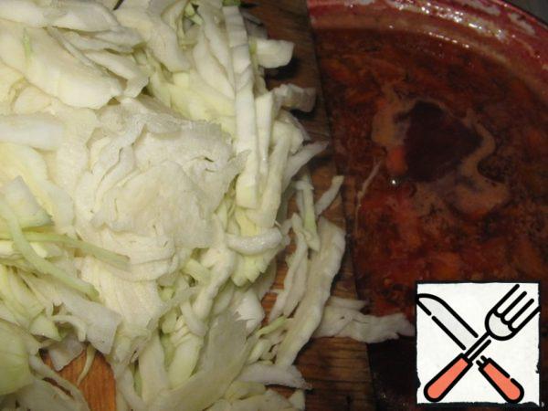 Cook for 5 minutes. During this time we will cut the cabbage thinly.
Put the cabbage in the borscht. Cook for 5 minutes.
Add the chopped herbs and some more garlic, but it is not for everybody. The borscht is ready!