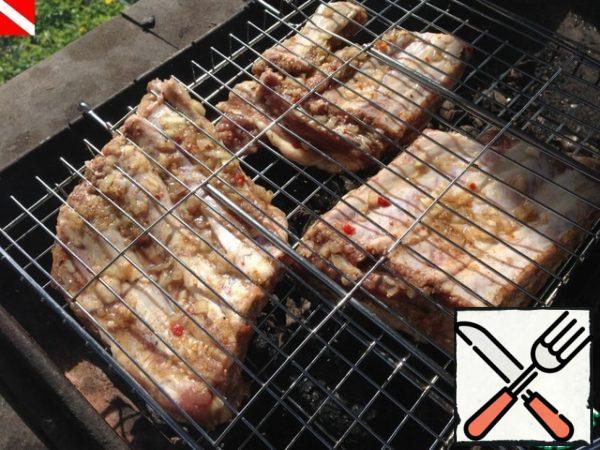 Heat the coals to the maximum, put the ribs on the grid. 