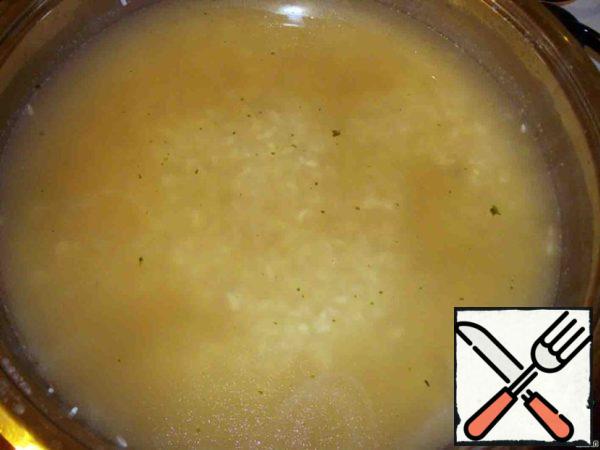Make the fire less and gently stirring, slowly pour the broth into the rice.