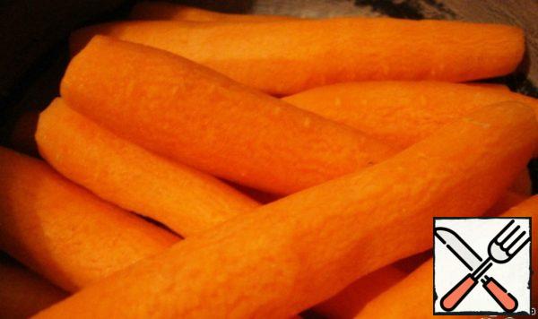 Peel raw carrots.