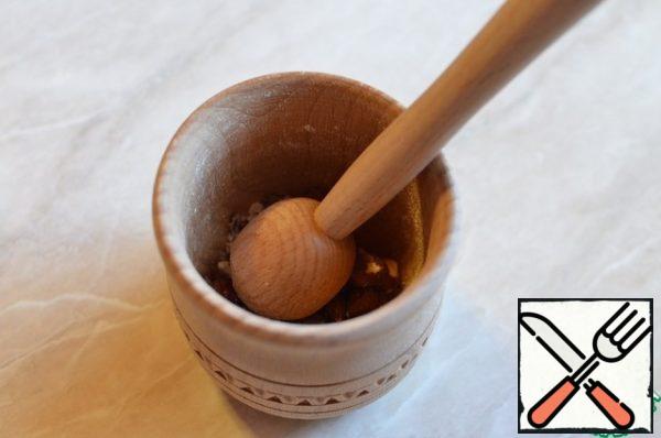 Chop the nuts or grind them in a mortar.
