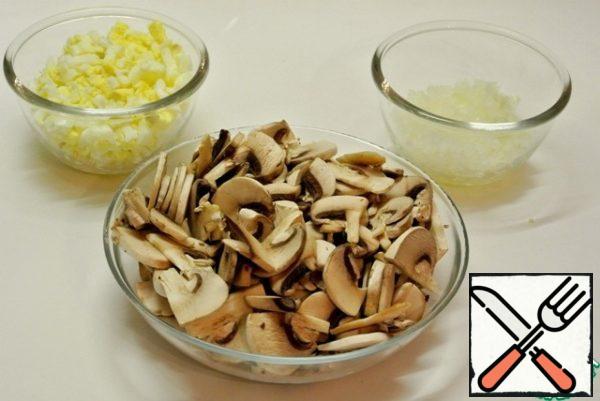 Boil eggs, clean, cool, cut into cubes. Peel the onion and chop it finely. Mushrooms, cleaned, cut into slices.