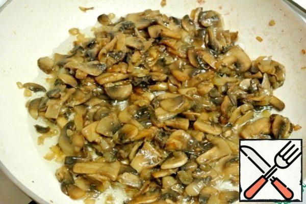 Mushrooms fry with onions in a pan with heated vegetable oil, salt and pepper.