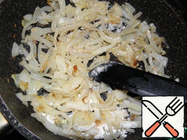 Add flour to the onion and fry for another minute, stirring constantly.