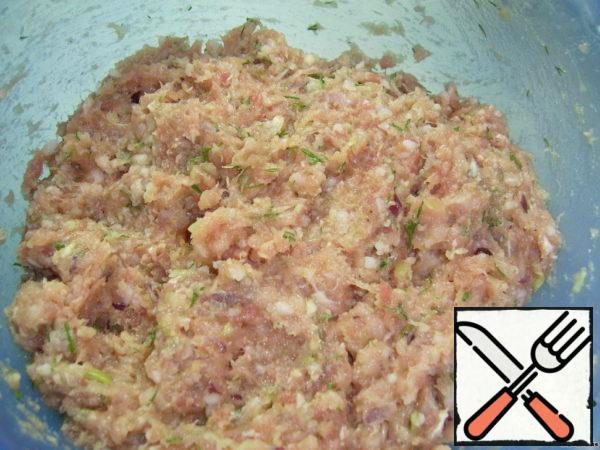 Add egg yolks, chopped greens, salt, pepper  into the minced meat and mix everything thoroughly.
