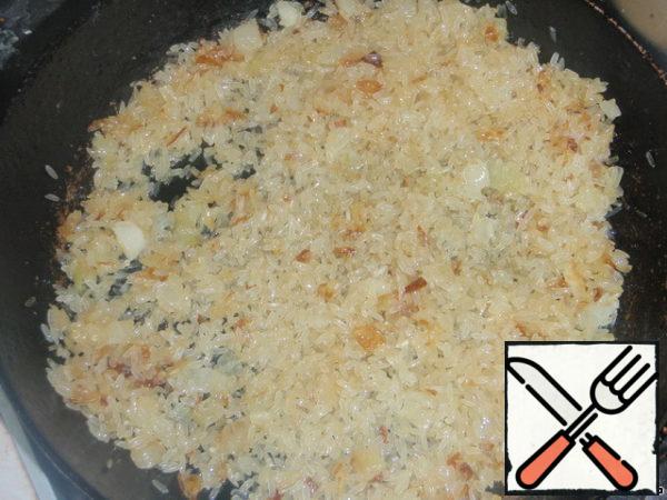 Add rice and fry it until it is transparent, it will take just a minute.