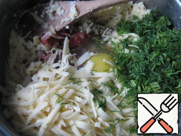 Add dill, grated cheese and egg to the porridge.
