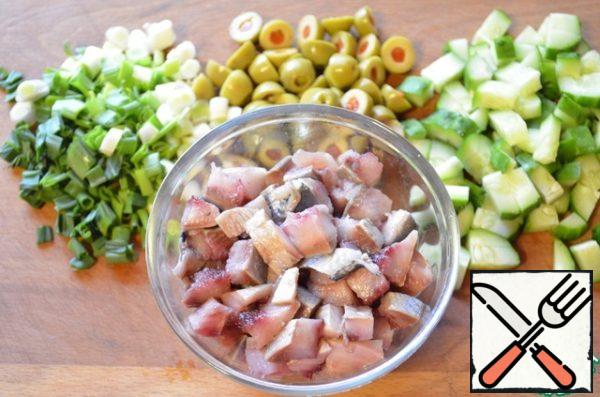 While the beans are cooking, I chop herring, cucumber, olives and green onions.
