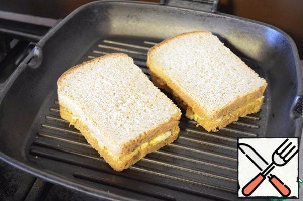 Fry in a grill pan on both sides. It turns out a sandwich with a super crispy crust and a delicate filling inside.