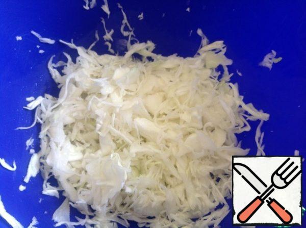 Finely chop the cabbage, add a little salt and mash with your hands.
