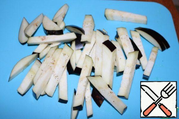 Cut the eggplant into strips. Sprinkle with salt and let stand.
