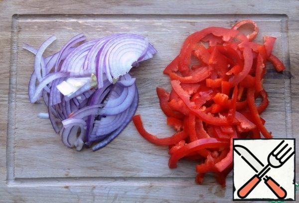 Onions and bell pepper cut into half rings.