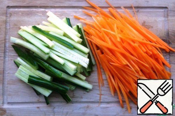 Carrots and cucumber cut into strips.