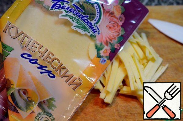 Cut the cheese into strips.
