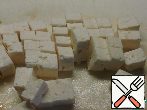 Cut the cheese into cubes.
